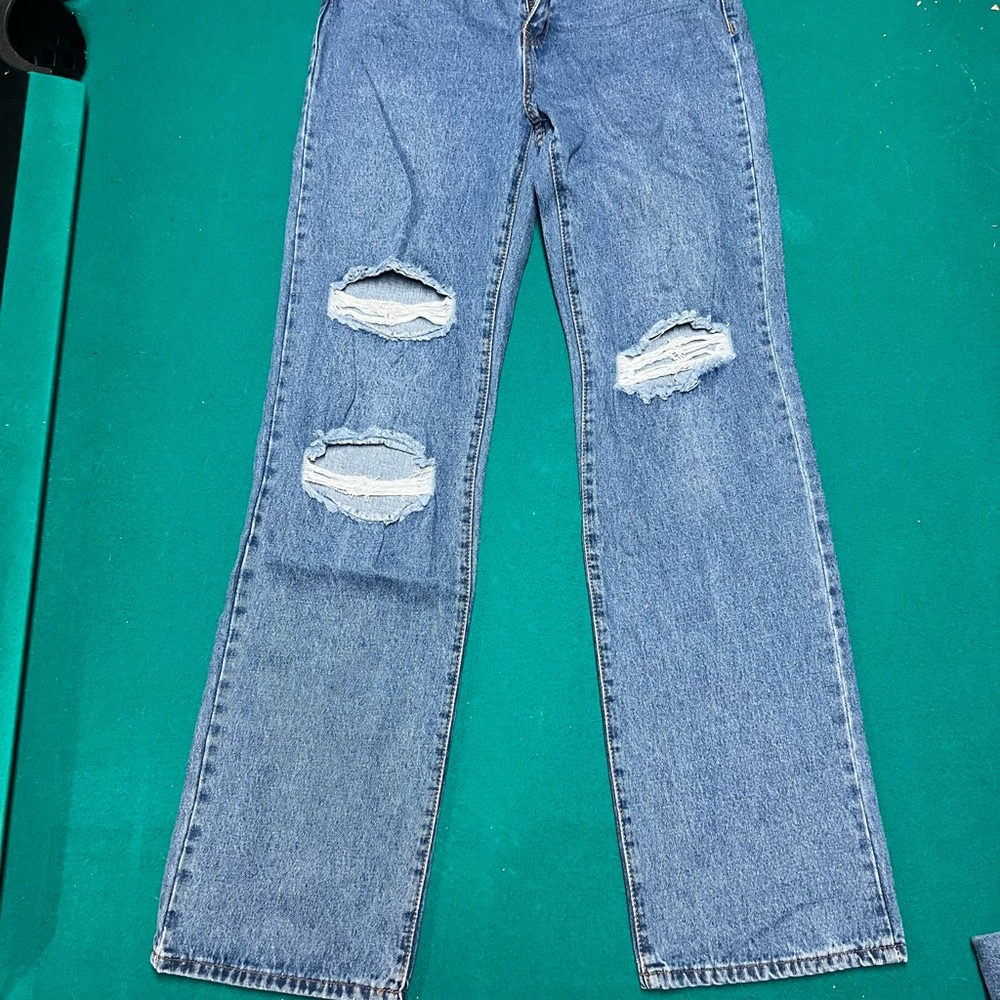 High-waisted wide leg blue denim jeans with distressed details